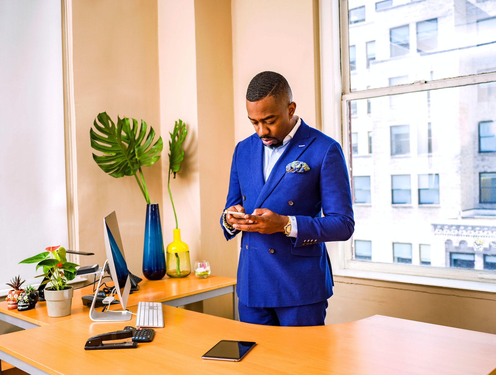 Man Standing While Using Phone